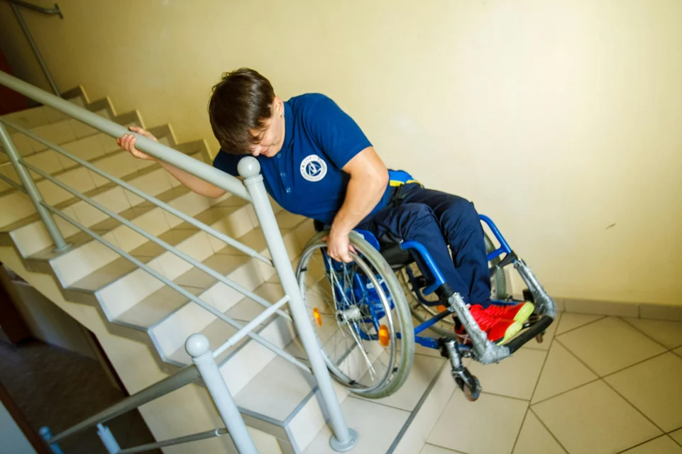 Man in wheelchair going down the stairs